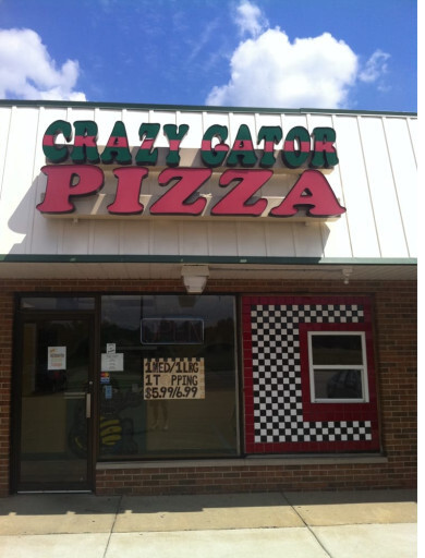 Real exterior of Crazy Gator Pizza storefront in Highland, MI